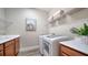 Laundry room with washer, dryer, utility sink, and shelving at 5846 Cavano Dr, Sarasota, FL 34231