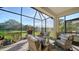Relaxing screened porch with wicker furniture and view of the pond at 5846 Cavano Dr, Sarasota, FL 34231
