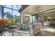 Spacious screened porch with wicker furniture and access to backyard at 5846 Cavano Dr, Sarasota, FL 34231