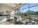 Outdoor kitchen and screened porch with wicker furniture at 5846 Cavano Dr, Sarasota, FL 34231