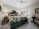 Spacious bedroom with a green four-poster bed and sitting area at 6161 Gulf Of Mexico Dr, Longboat Key, FL 34228