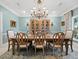 Elegant dining room featuring a large wooden table and chandelier at 6161 Gulf Of Mexico Dr, Longboat Key, FL 34228