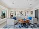 Spacious living room with curved sofa and large windows at 6161 Gulf Of Mexico Dr, Longboat Key, FL 34228