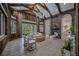 Spacious living room features wood walls, high ceilings, a stone fireplace, and ample natural light at 6200 Saddle Oak Trl, Sarasota, FL 34241