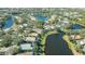 Aerial perspective of a residential area with houses by the lake at 6523 Virginia Xing, University Park, FL 34201