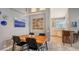 Dining area with kitchen views, wood table, and modern chairs at 6523 Virginia Xing, University Park, FL 34201