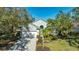 Beautiful light green house with white garage door and lush landscaping at 6523 Virginia Xing, University Park, FL 34201