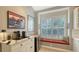 Built-in kitchen nook with window seat and custom cabinetry at 6523 Virginia Xing, University Park, FL 34201