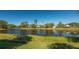 Scenic view of a peaceful lake with lush vegetation at 6523 Virginia Xing, University Park, FL 34201