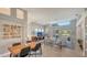 Open living space with high ceilings, tiled floors, and a pool view at 6523 Virginia Xing, University Park, FL 34201