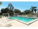 Inviting community pool with lounge chairs and a pergola for shade at 6523 Virginia Xing, University Park, FL 34201