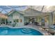 Outdoor entertaining area with pool, summer kitchen, and seating at 6523 Virginia Xing, University Park, FL 34201