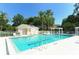 Relaxing community pool area with a pool house and ample lounge chairs at 6523 Virginia Xing, University Park, FL 34201