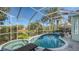 Relaxing kidney-shaped pool with spa and screened enclosure at 6523 Virginia Xing, University Park, FL 34201