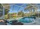 Enjoy the screened pool and spa with a peaceful lake view at 6523 Virginia Xing, University Park, FL 34201