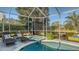 Enjoy the screened pool and spa with a peaceful lake view at 6523 Virginia Xing, University Park, FL 34201