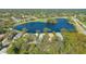 Bird's eye view of a house near a lake and golf course at 6525 Berkshire Pl, University Park, FL 34201