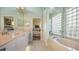Spa-like bathroom with a soaking tub and glass block window at 6525 Berkshire Pl, University Park, FL 34201