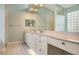 Double vanity bathroom with a large mirror and tiled floors at 6525 Berkshire Pl, University Park, FL 34201