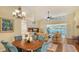 Open dining room with hardwood floors and view to living room at 6525 Berkshire Pl, University Park, FL 34201