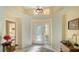 Bright entryway with high ceilings and a glass front door at 6525 Berkshire Pl, University Park, FL 34201