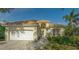 Single-story house with a white garage door and landscaped front yard at 6525 Berkshire Pl, University Park, FL 34201