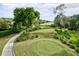 Golf course with lush greens and mature trees at 6525 Berkshire Pl, University Park, FL 34201