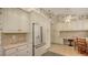 Kitchen boasts white cabinets, granite countertops, and built-in desk at 6525 Berkshire Pl, University Park, FL 34201