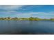 Tranquil lake view with homes and golf course in background at 6525 Berkshire Pl, University Park, FL 34201