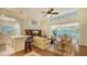 Living room with high ceilings, hardwood floors, and access to a sunroom at 6525 Berkshire Pl, University Park, FL 34201