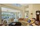 Spacious living room with view of lake from sunroom at 6525 Berkshire Pl, University Park, FL 34201