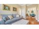 Bright living room with hardwood floors, comfy couch, and view to dining area at 6525 Berkshire Pl, University Park, FL 34201