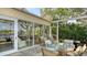 Relaxing patio with glass enclosure and lake view at 6525 Berkshire Pl, University Park, FL 34201
