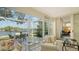 Sunroom with patio access and view of lake and golf course at 6525 Berkshire Pl, University Park, FL 34201