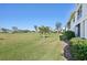 Landscaped backyard with golf course view at 760 Village Cir # 109, Venice, FL 34292