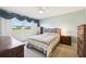 Cozy bedroom with a double bed, dresser, and view of the golf course at 760 Village Cir # 109, Venice, FL 34292