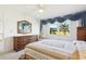 Spacious bedroom with a double bed, dresser, and large windows with golf course view at 760 Village Cir # 109, Venice, FL 34292