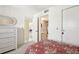Bedroom with white dresser and view into living area and bathroom at 760 Village Cir # 109, Venice, FL 34292