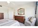 Bedroom with double bed, dresser, and chair, next to the bathroom at 760 Village Cir # 109, Venice, FL 34292