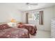 Bedroom with two twin beds, dresser, and view from the window at 760 Village Cir # 109, Venice, FL 34292