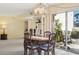 Cozy dining area with table and chairs, and access to patio at 760 Village Cir # 109, Venice, FL 34292