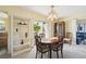 Bright dining room with table and chairs near patio at 760 Village Cir # 109, Venice, FL 34292