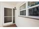 Condo entrance with screen door and windows at 760 Village Cir # 109, Venice, FL 34292