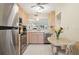 Galley kitchen with stainless steel appliances and breakfast bar at 760 Village Cir # 109, Venice, FL 34292