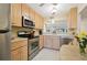 Efficient kitchen with stainless steel appliances at 760 Village Cir # 109, Venice, FL 34292