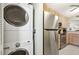 Stackable washer and dryer, and kitchen view at 760 Village Cir # 109, Venice, FL 34292