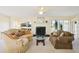 Living room with fireplace and view from large windows at 760 Village Cir # 109, Venice, FL 34292
