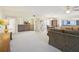 Bright living room with open floor plan, featuring a view of the kitchen and dining area at 760 Village Cir # 109, Venice, FL 34292