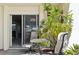 Private patio with seating and view into living area at 760 Village Cir # 109, Venice, FL 34292