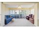 Bright sunroom features a comfy couch and chair, perfect for relaxing at 760 Village Cir # 109, Venice, FL 34292